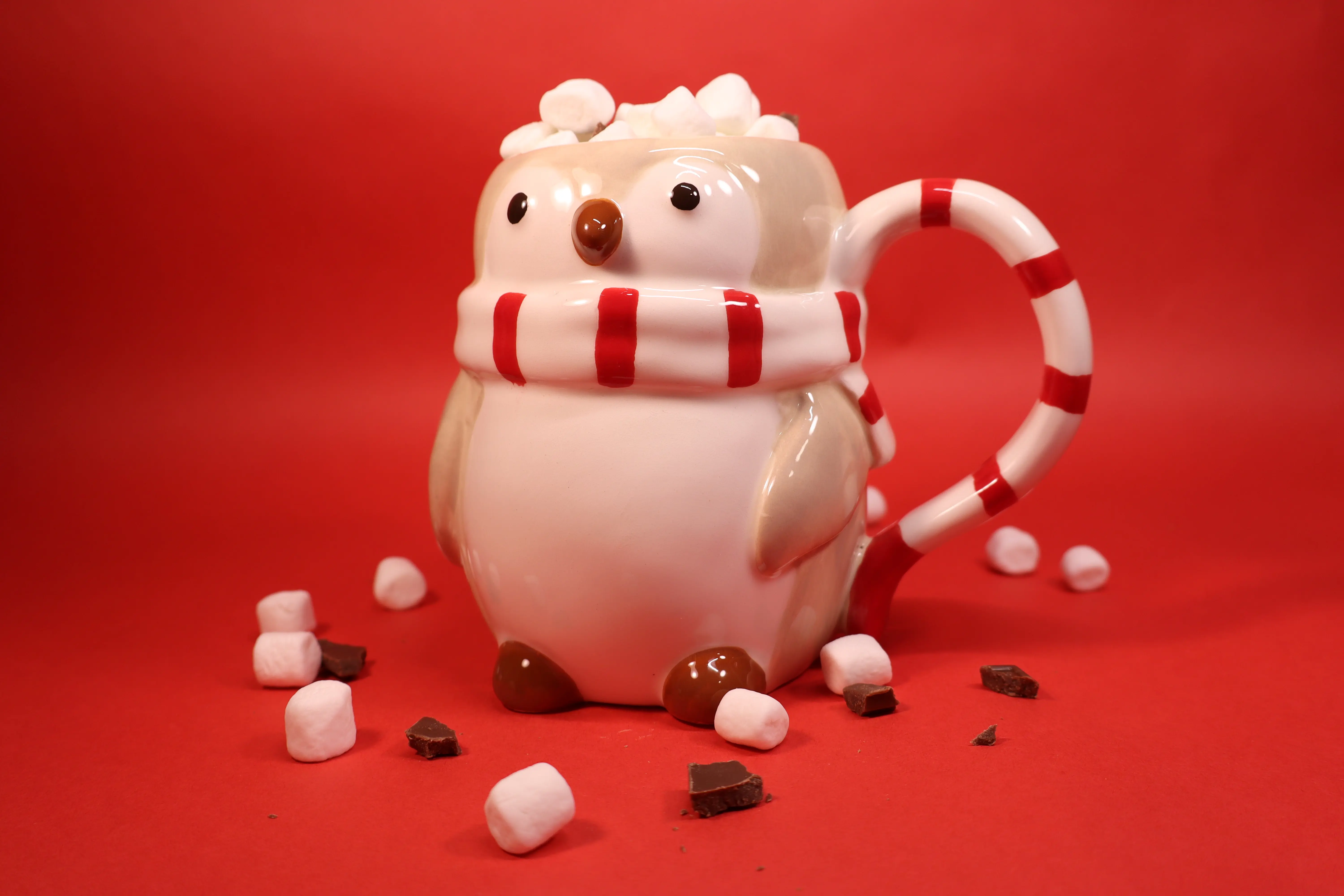 Penguin mug full of hot chocolate overflowing with marshmallows