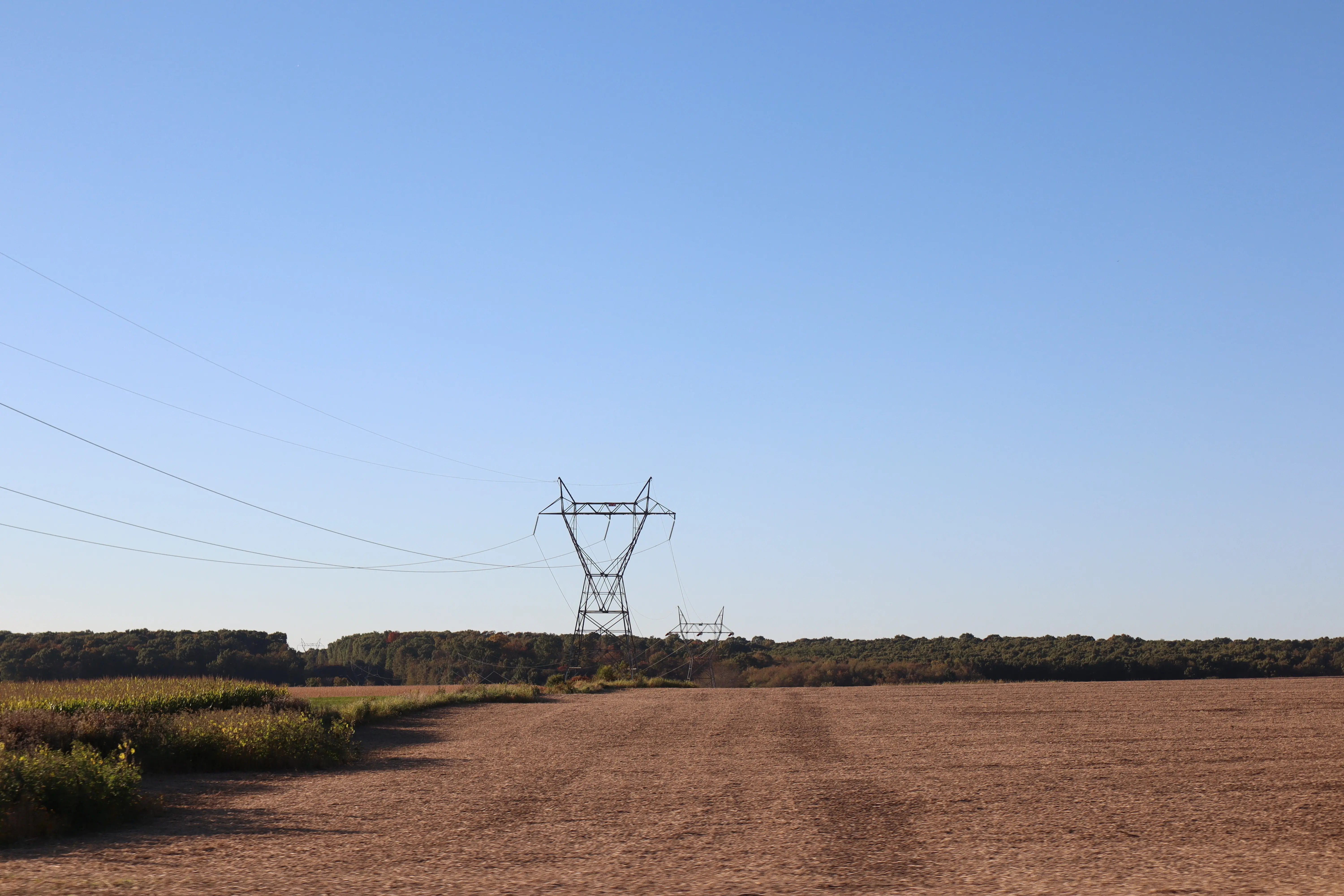 Large power lines by an empty field